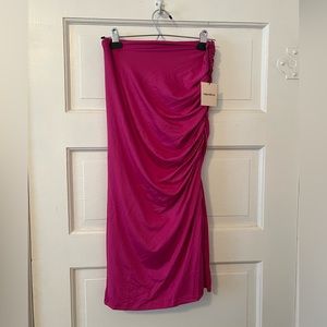 Fuchsia pink midi skirt. Stretchy material with side slit.